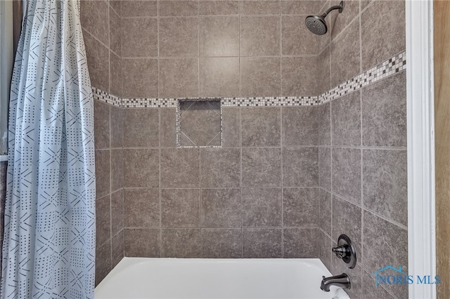 bathroom with shower / bathtub combination with curtain