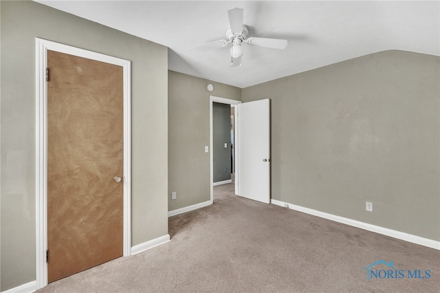 unfurnished bedroom with lofted ceiling, carpet, and ceiling fan