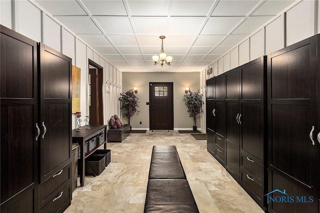 foyer with coffered ceiling and a notable chandelier