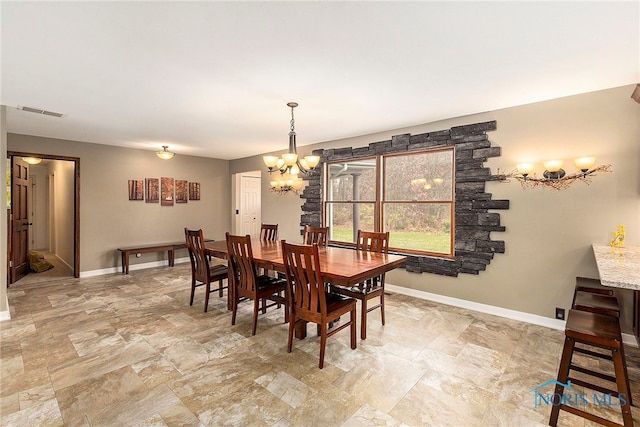 dining area with an inviting chandelier