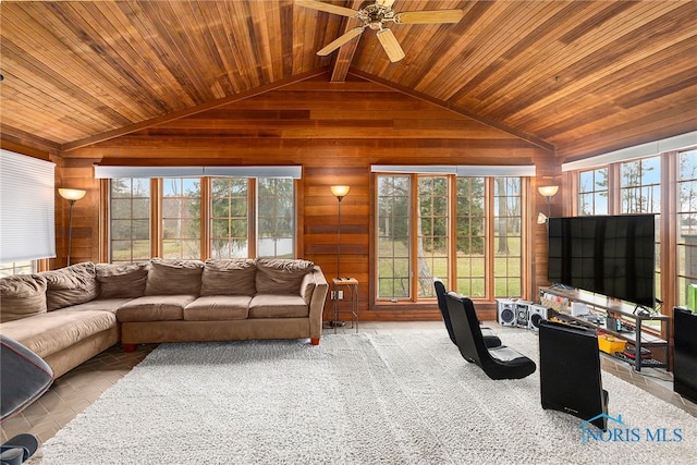 carpeted living room with a healthy amount of sunlight and wooden ceiling