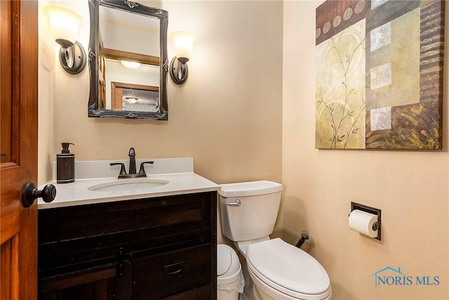 bathroom featuring vanity and toilet