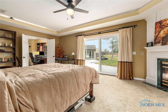 bedroom with a high end fireplace, carpet flooring, access to outside, and ceiling fan