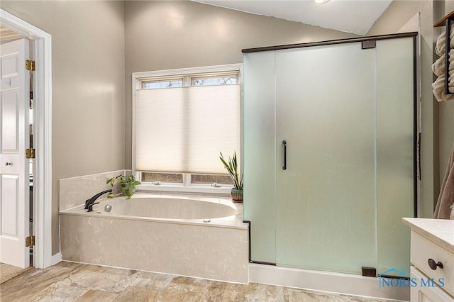 bathroom featuring shower with separate bathtub, lofted ceiling, and vanity