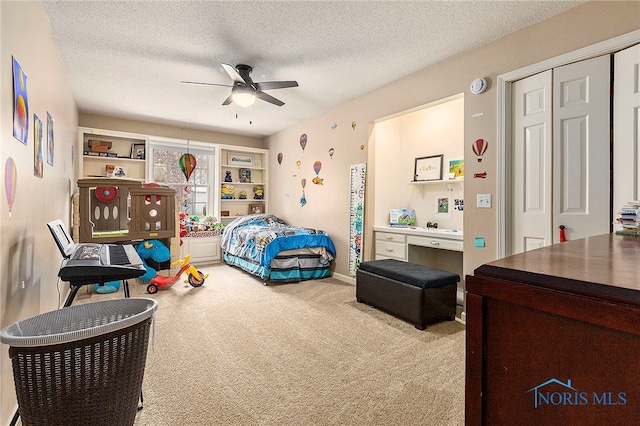 carpeted bedroom with a textured ceiling and ceiling fan