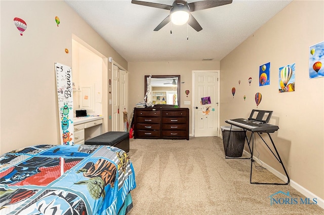 carpeted bedroom featuring ceiling fan and a textured ceiling