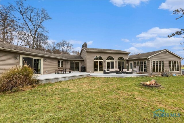 rear view of house with a patio area and a yard