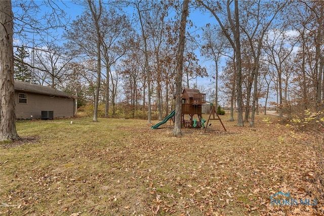 view of yard with a playground and central AC unit