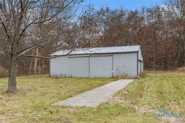 view of outbuilding with a lawn