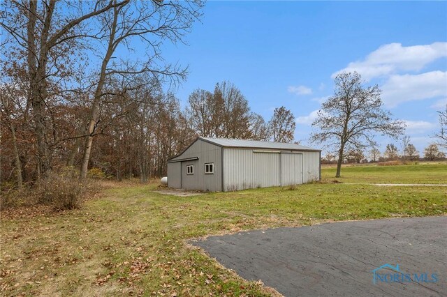 view of outbuilding with a yard