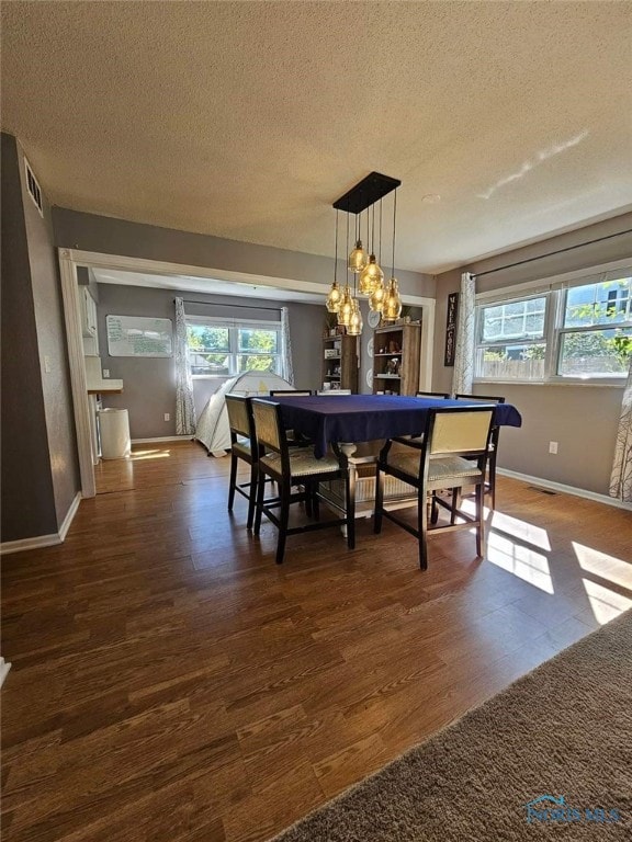 dining room with a textured ceiling, dark wood-type flooring, and pool table