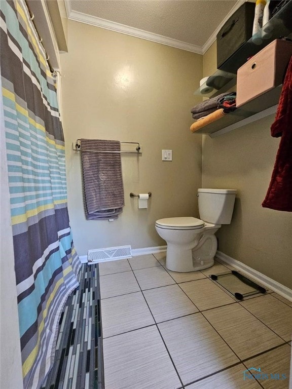 bathroom featuring tile patterned flooring, toilet, and crown molding