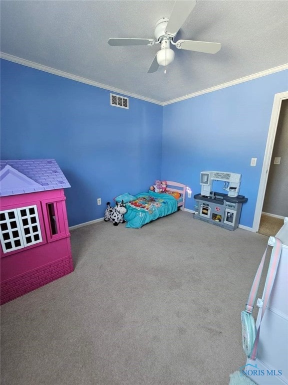 carpeted bedroom with a textured ceiling, ceiling fan, and crown molding