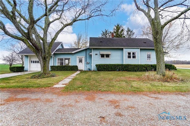 single story home with a garage and a front lawn