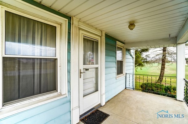 view of exterior entry with covered porch