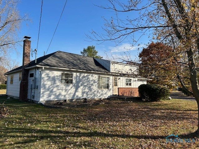 rear view of property with a yard