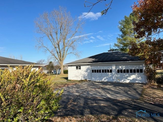 view of side of home featuring a garage