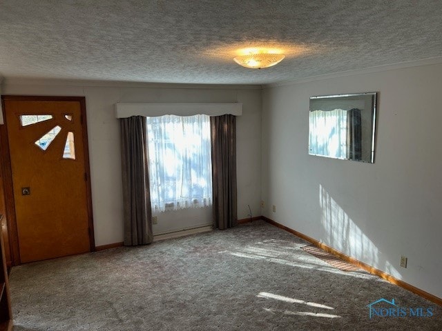 empty room with a textured ceiling and carpet floors