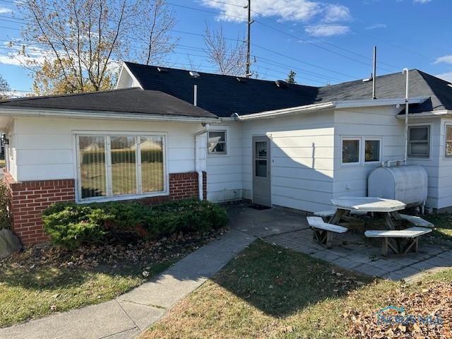 1811 E Wilson, Bryan, OH 43506 - rear view of property featuring a patio area, brick siding, and heating fuel