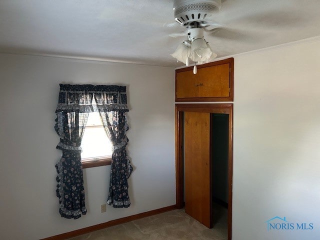 interior space with crown molding and ceiling fan