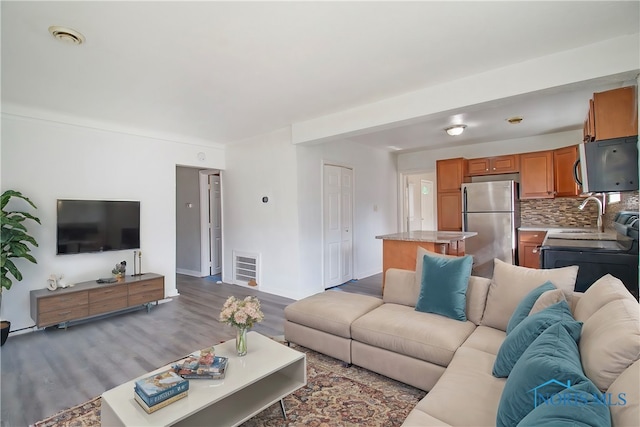 living room featuring sink and light wood-type flooring