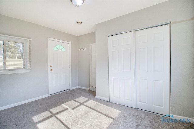 view of carpeted foyer