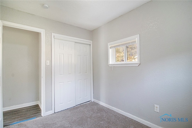 unfurnished bedroom with carpet floors and a closet