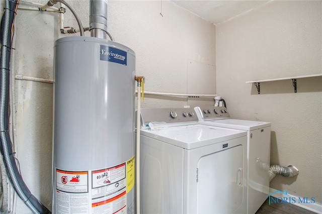 laundry room with washer and clothes dryer and gas water heater