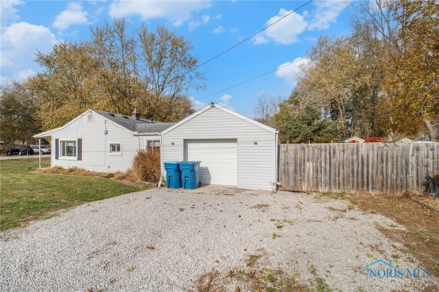 view of side of home with a yard and a garage