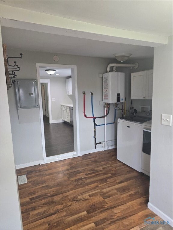 clothes washing area featuring washer and dryer, dark hardwood / wood-style flooring, water heater, cabinets, and electric panel