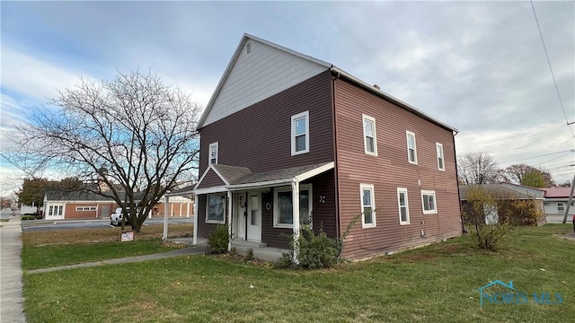 221 W Jackson St, Paulding, OH 45879 - view of side of home featuring a yard and a porch