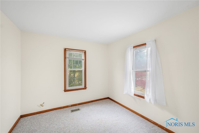 carpeted empty room with plenty of natural light