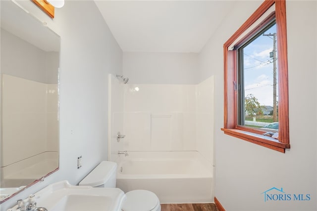 full bathroom featuring bathtub / shower combination, sink, hardwood / wood-style flooring, and toilet