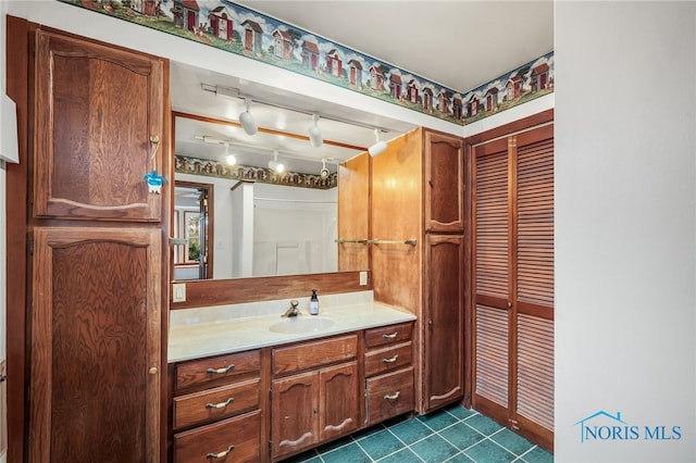 bathroom featuring vanity and rail lighting