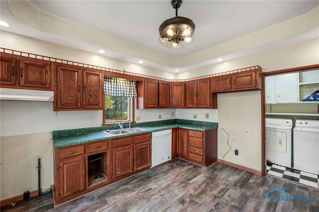 kitchen with sink, white dishwasher, dark hardwood / wood-style flooring, and washing machine and clothes dryer