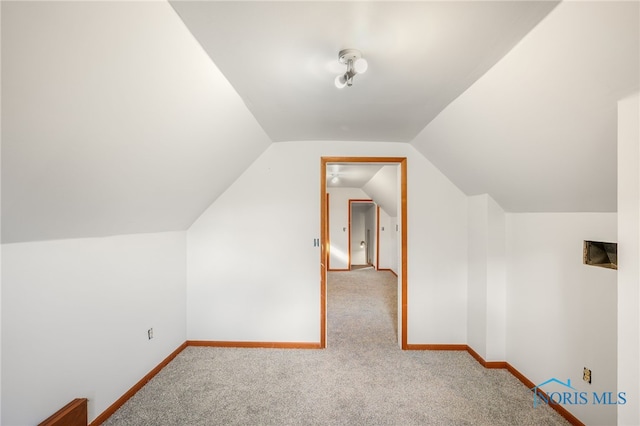 additional living space with vaulted ceiling and carpet floors