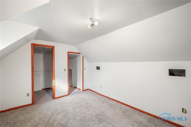 bonus room with carpet and vaulted ceiling