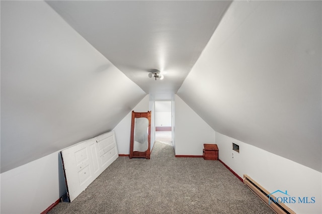 bonus room with lofted ceiling, a baseboard heating unit, and light colored carpet