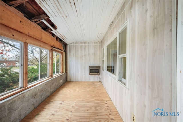 unfurnished sunroom with heating unit