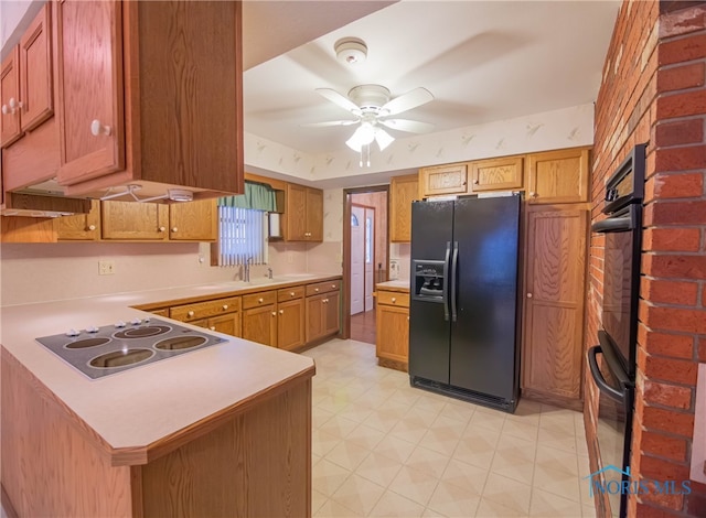 kitchen with kitchen peninsula, sink, ceiling fan, and black appliances