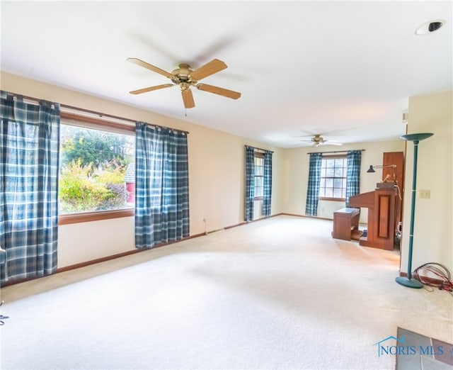 living room featuring carpet flooring and ceiling fan