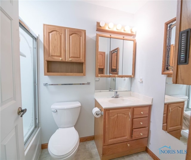 full bathroom with vanity, toilet, and combined bath / shower with glass door