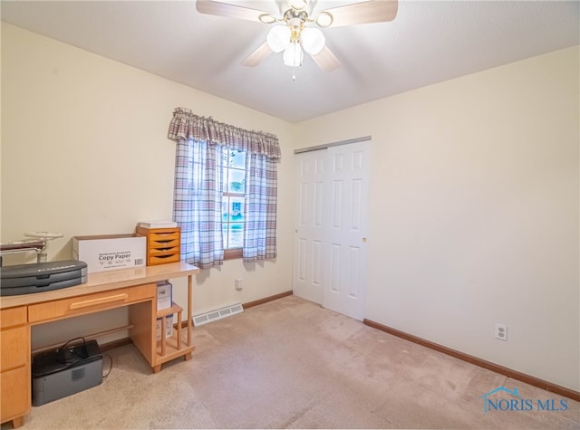 office with light colored carpet and ceiling fan