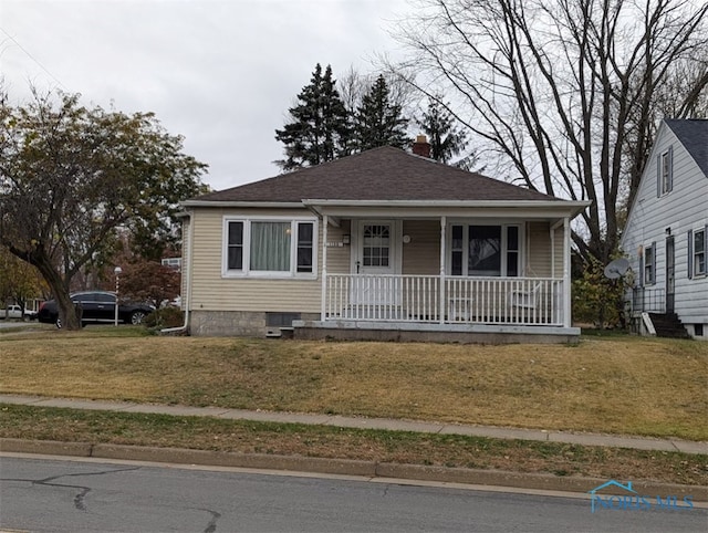 bungalow-style house featuring a porch and a front yard