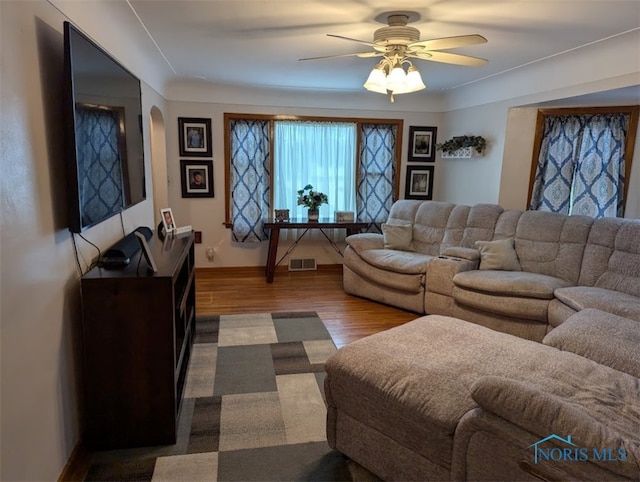 living room featuring hardwood / wood-style floors and ceiling fan