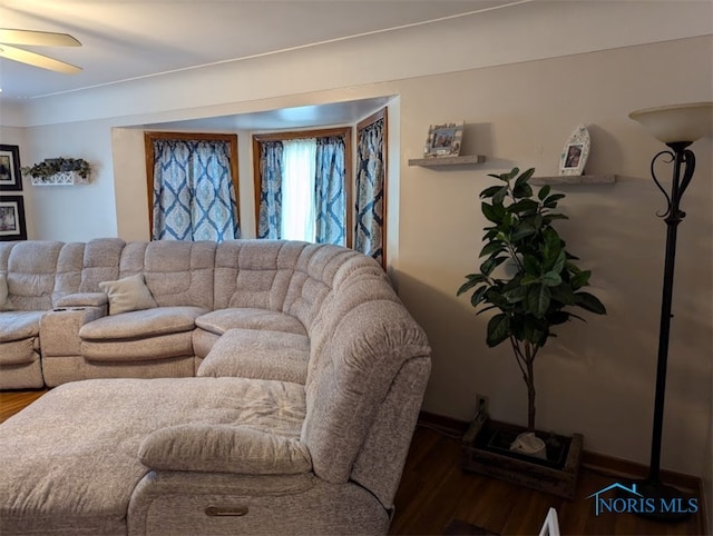 living room featuring wood-type flooring and ceiling fan