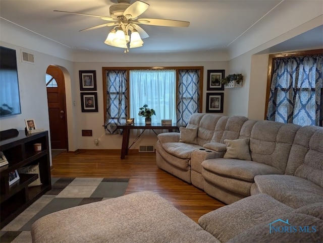 living room featuring hardwood / wood-style floors and ceiling fan