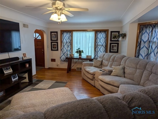 living room featuring hardwood / wood-style floors and ceiling fan