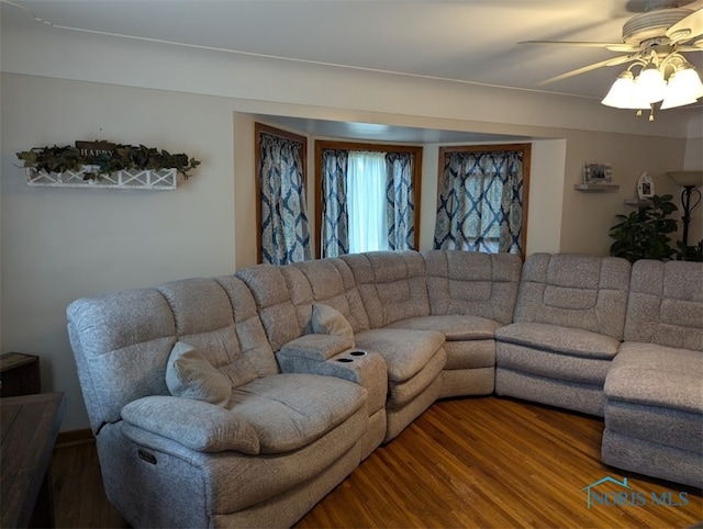 living room featuring hardwood / wood-style floors and ceiling fan