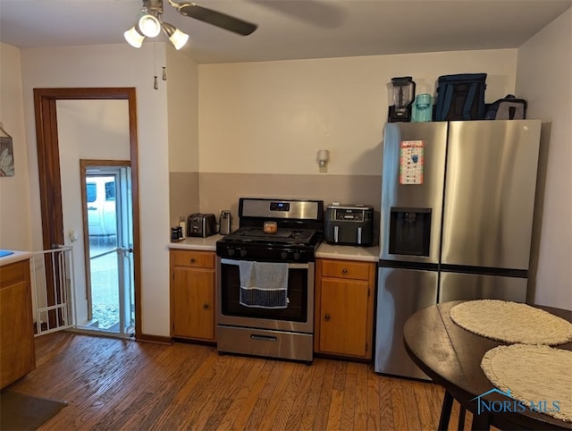 kitchen featuring hardwood / wood-style floors, ceiling fan, and stainless steel appliances